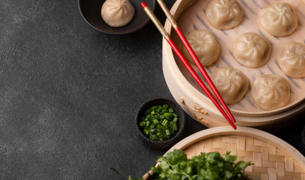 Download Dumplings, Chopsticks And Vegetables On A Dark Background