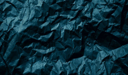 A dark blue crumpled paper background photo