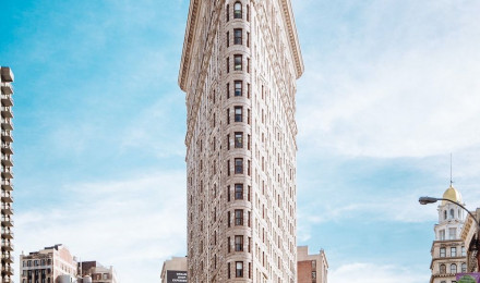 Beige concrete building near cars photo