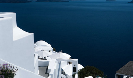 White concrete building near body of water during daytime photo