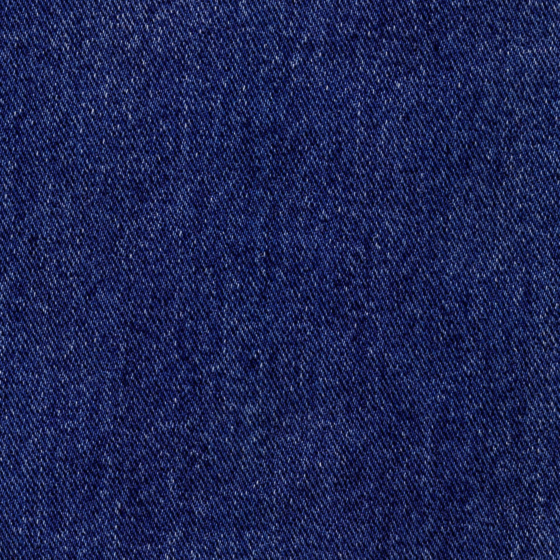 Blue denim square, background of textured jeans material