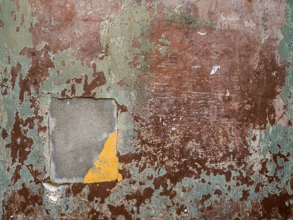 A rusted wall with a hole in it. Texture background walls, background textures. Domain Media Search Engine Public Domain Search