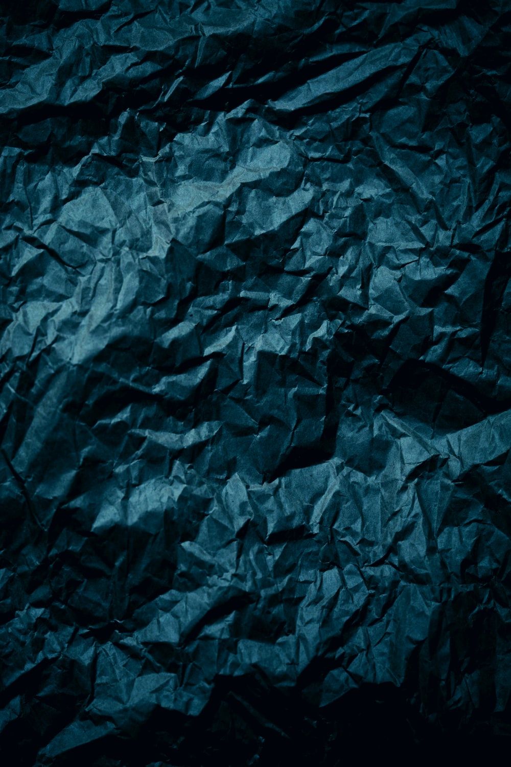 A dark blue crumpled paper background photo