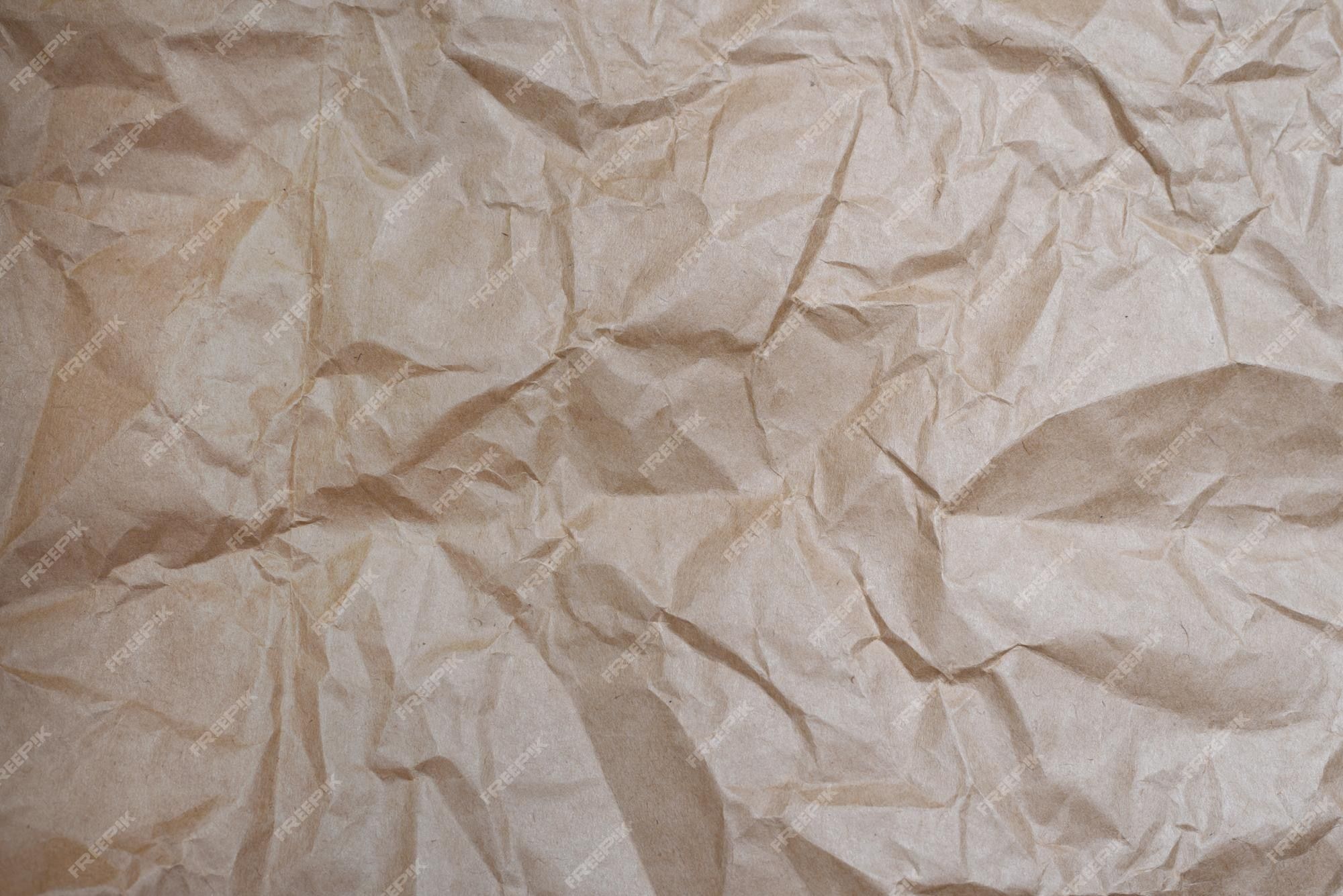 Premium Photo. Close up craft crumpled beige paper for background usage cope space