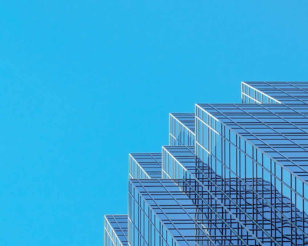 White and blue concrete building under blue sky during daytime photo