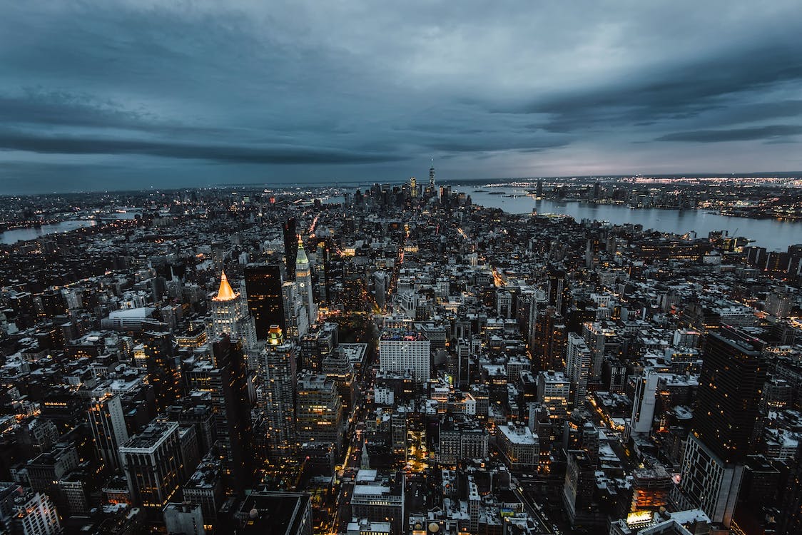 Grey Concrete Buildings Under Cloudy Sky · Free