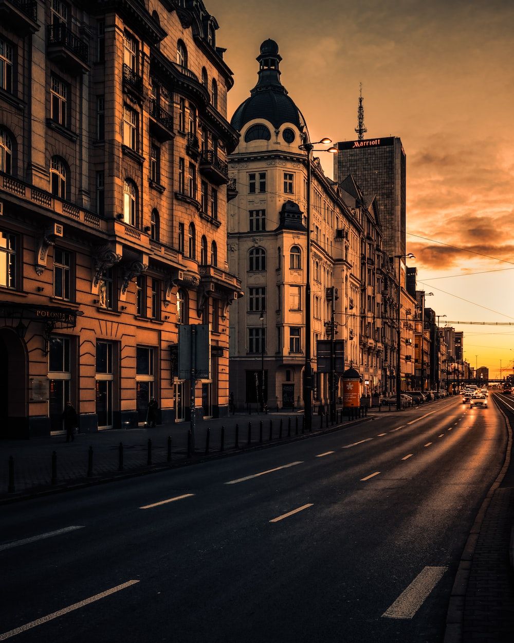 Brown concrete building beside road during daytime photo