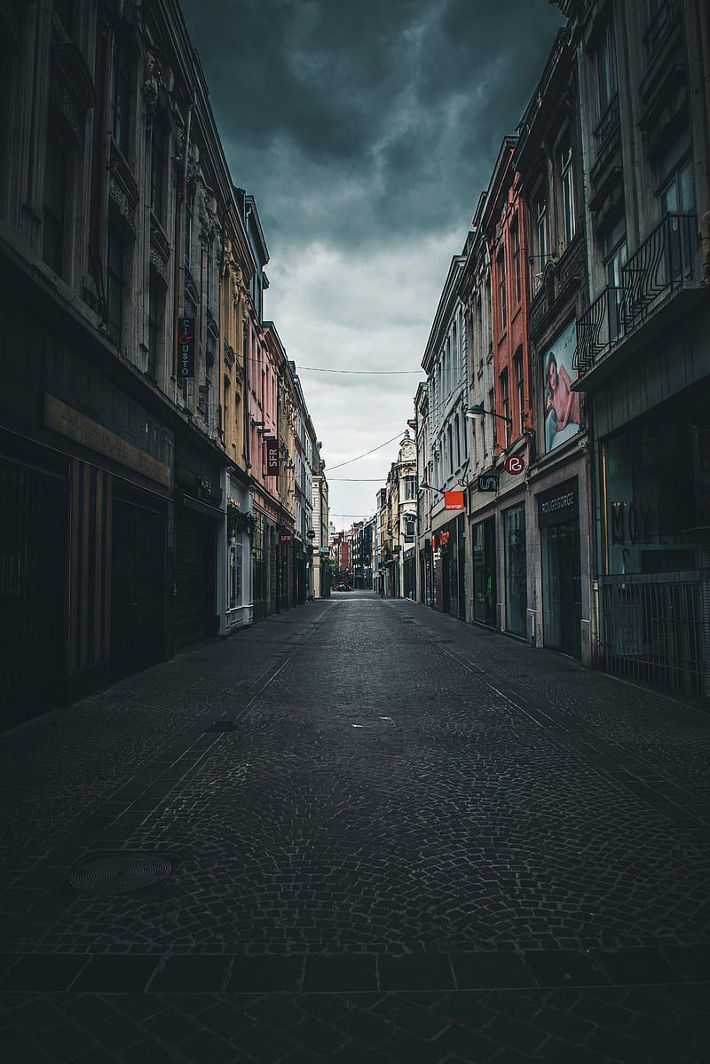 Empty road between concrete buildings under white clouds during daytime, HD phone wallpaper